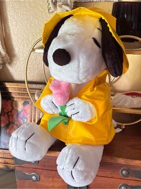 Peanuts Snoopy Plush in Yellow Raincoat Holding Pink Flower